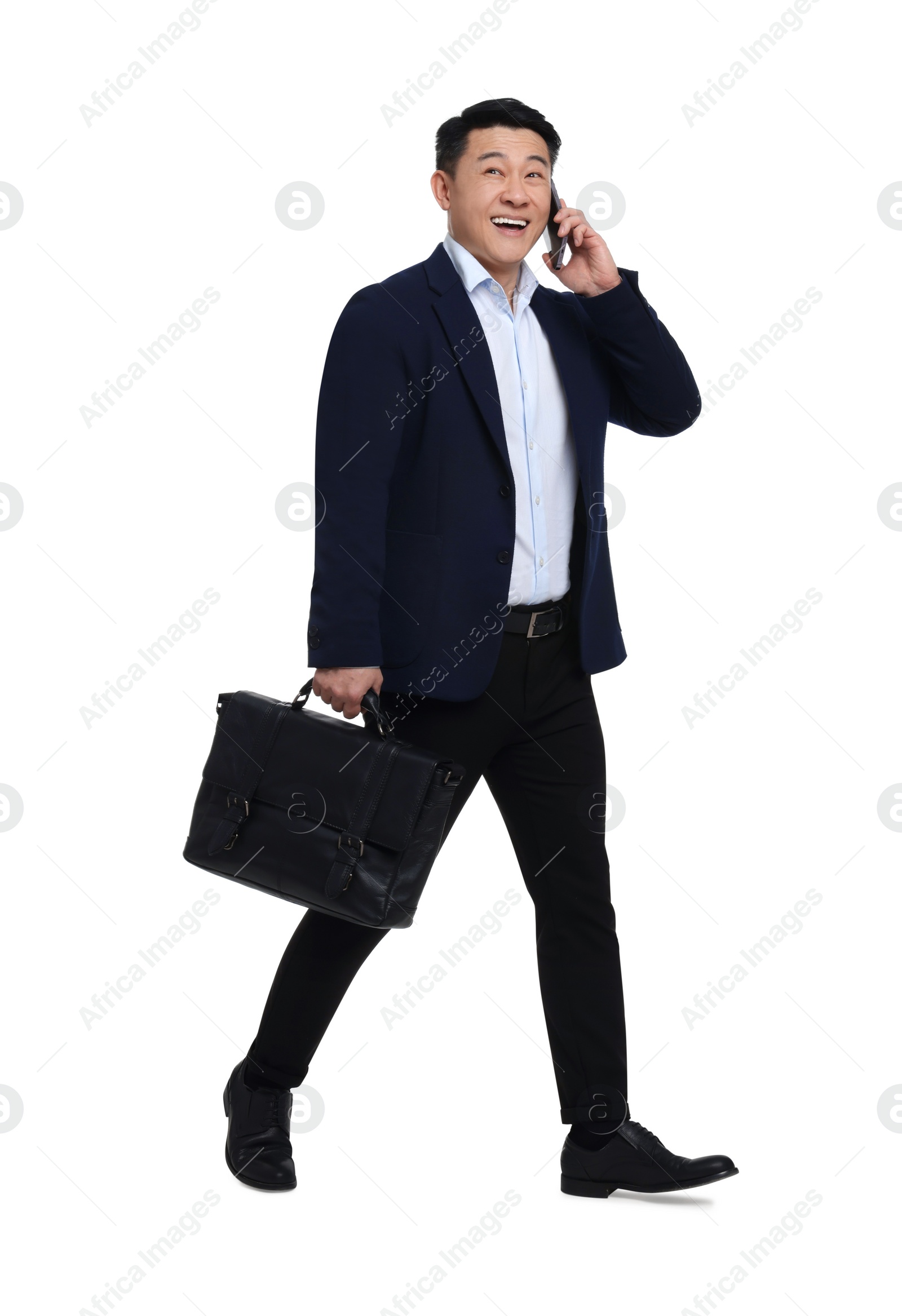 Photo of Businessman in suit with briefcase walking on white background