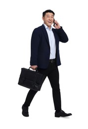 Photo of Businessman in suit with briefcase walking on white background