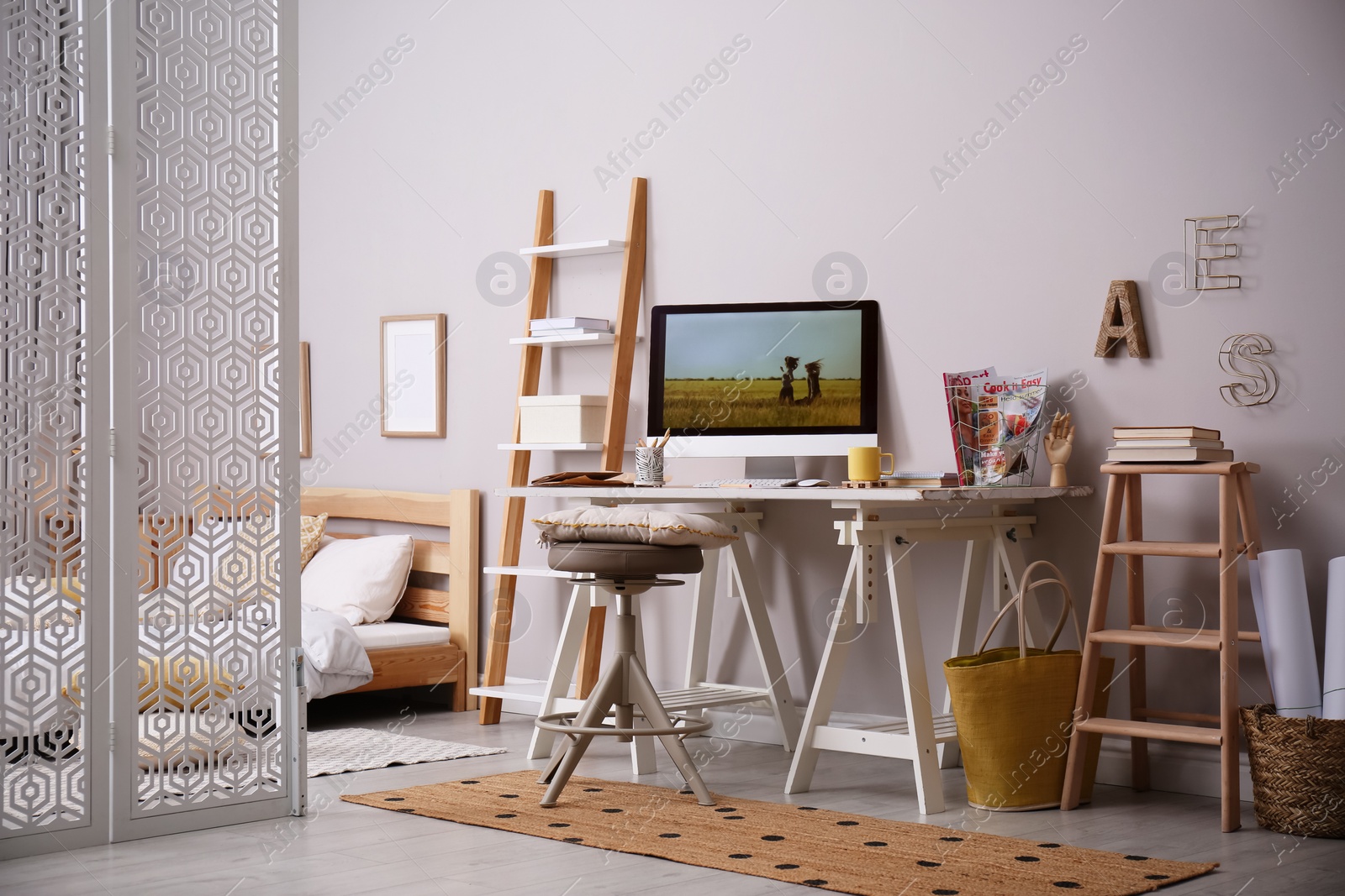 Photo of Comfortable workplace with modern computer near light wall. Interior design