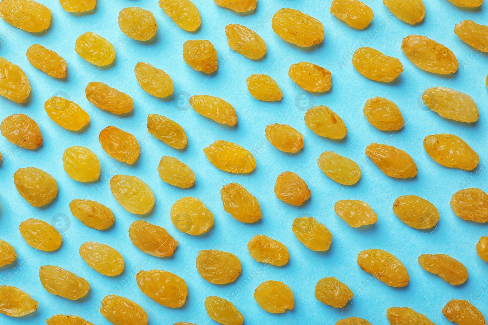 Photo of Flat lay composition with raisins on color background. Dried fruit as healthy snack