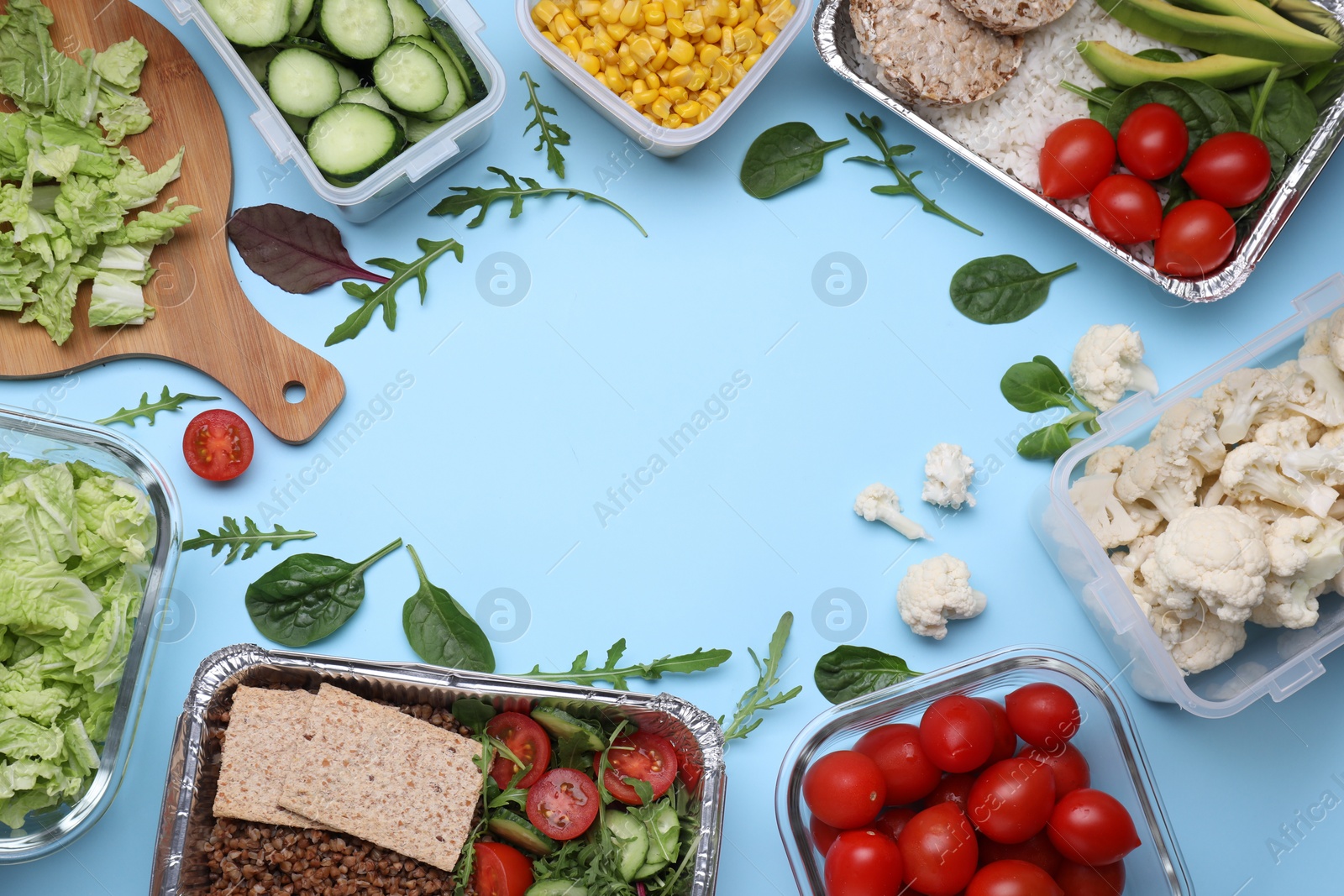 Photo of Flat lay composition with different containers of fresh products on light blue background. Space for text