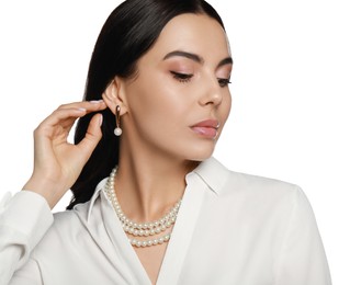 Photo of Young woman wearing elegant pearl jewelry on white background