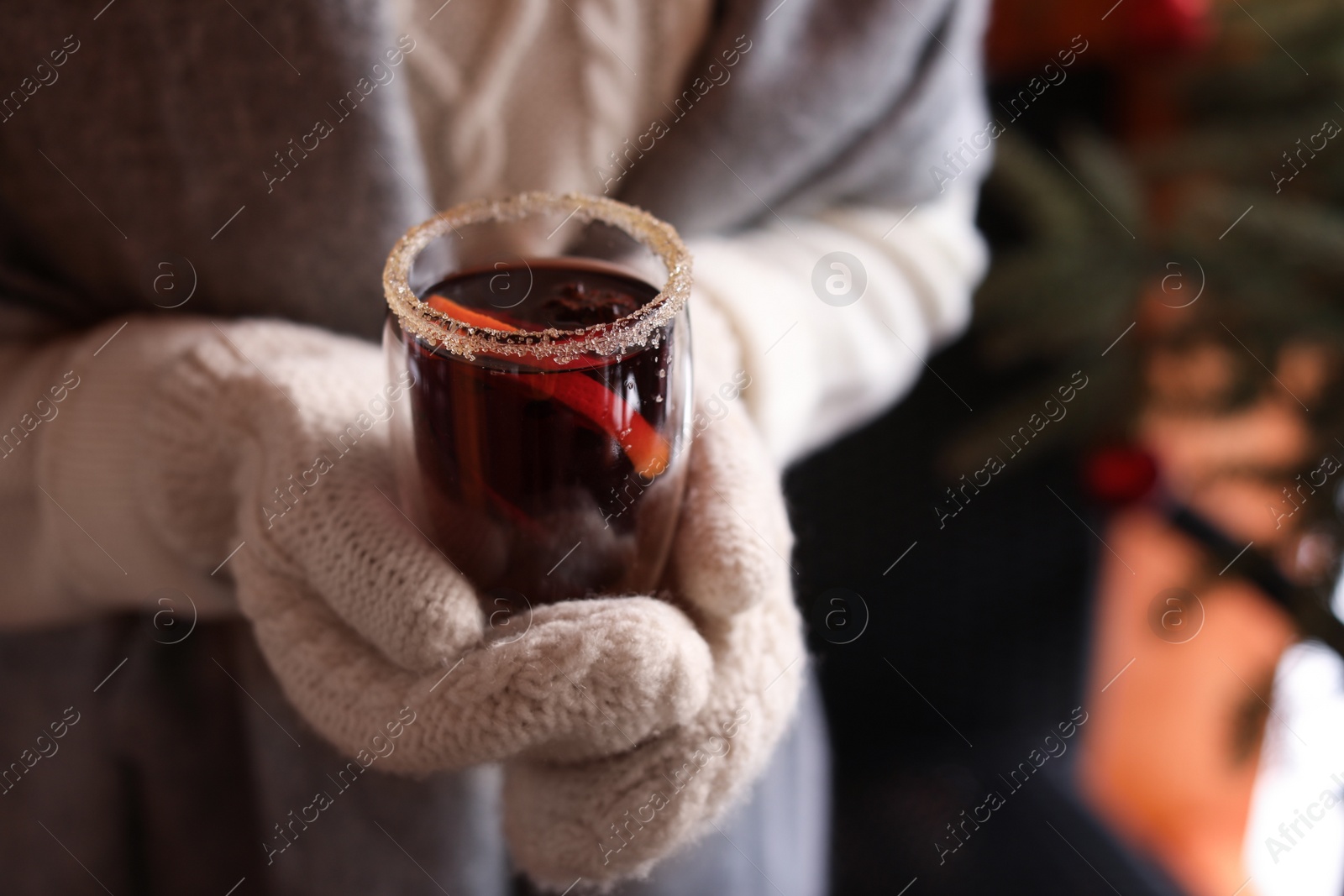 Photo of Woman with tasty mulled wine outdoors, closeup