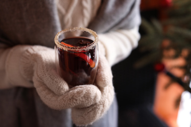 Photo of Woman with tasty mulled wine outdoors, closeup