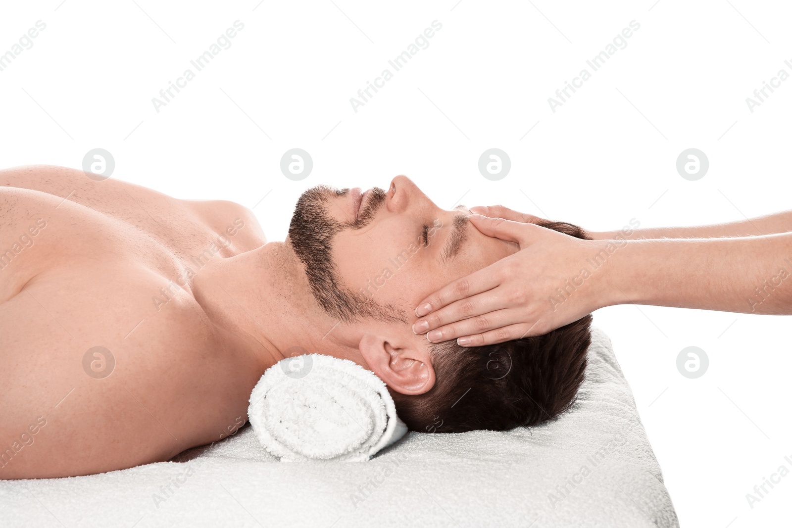 Photo of Handsome man receiving face massage on white background. Spa service