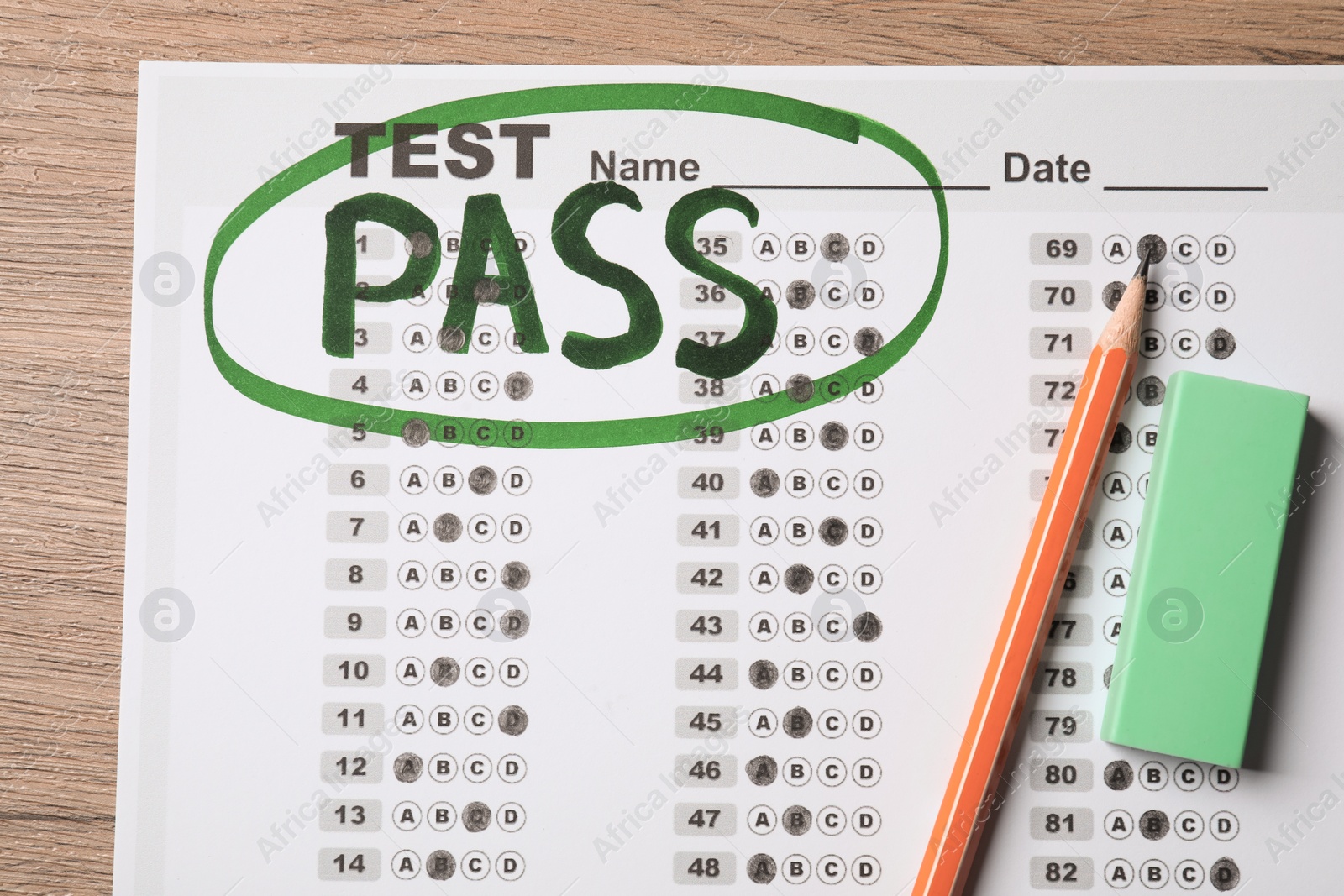 Photo of Answer sheet with word Pass, eraser and pencil on wooden table, flat lay. Student passing exam