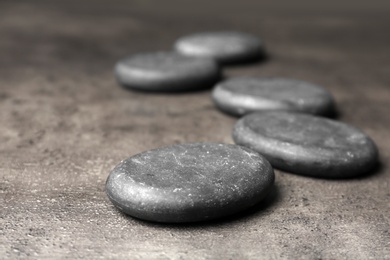 Spa stones on grey background. Space for text