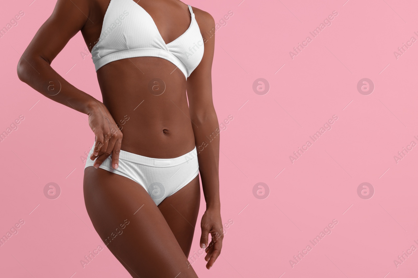 Photo of Woman in stylish bikini on pink background, closeup. Space for text