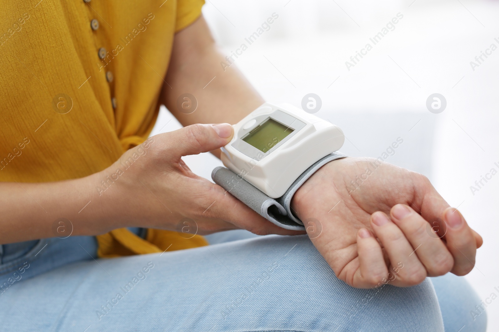 Photo of Woman checking blood pressure with sphygmomanometer at home, closeup. Cardiology concept