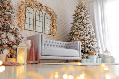 Beautiful interior of living room with decorated Christmas trees, low angle view