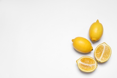 Many fresh ripe lemons on white background, top view