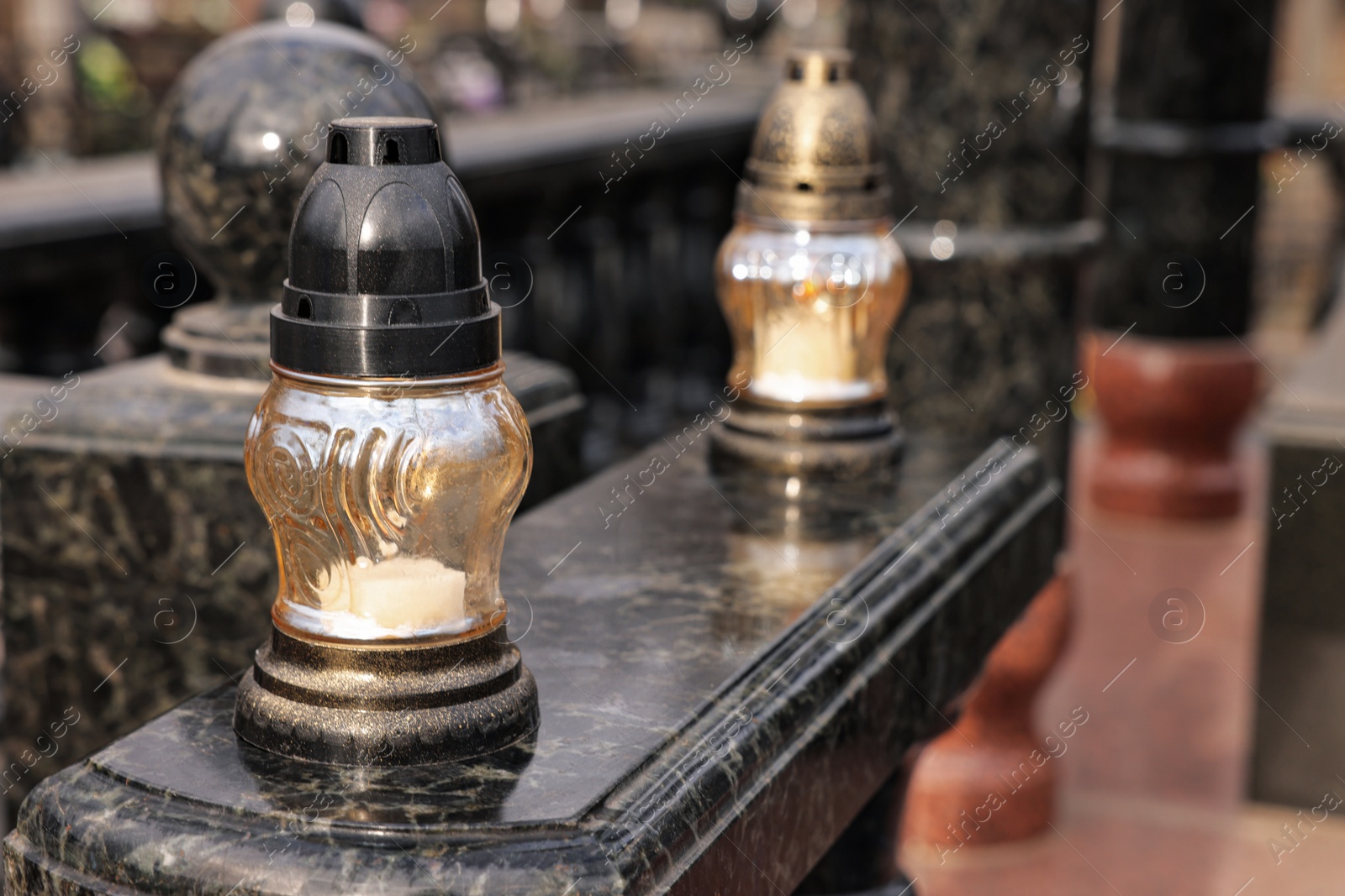 Photo of Grave lantern with candle on granite surface at cemetery, space for text