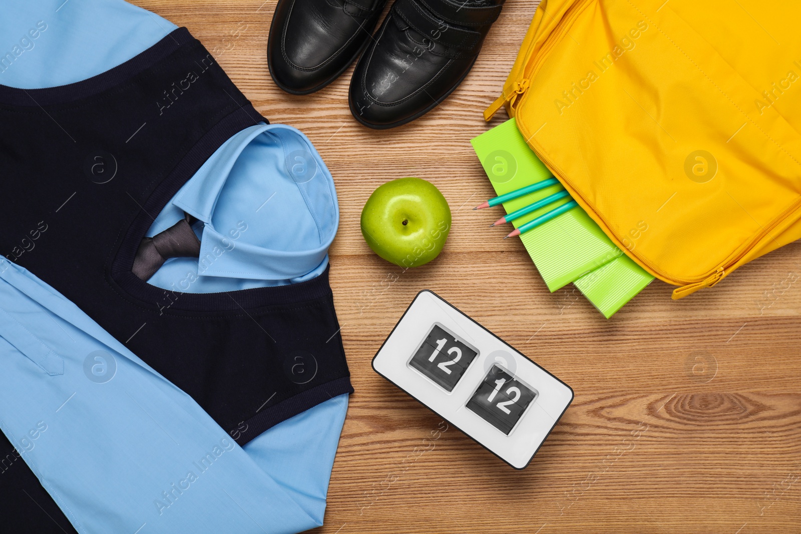 Photo of School uniform for boy and stationery on wooden background