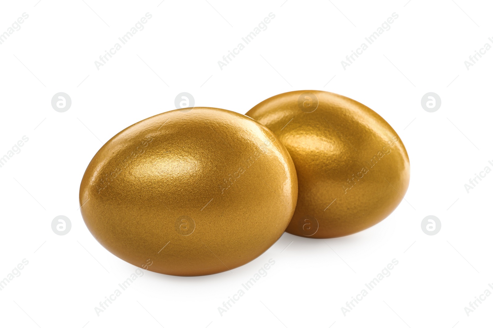 Photo of Two shiny golden eggs on white background