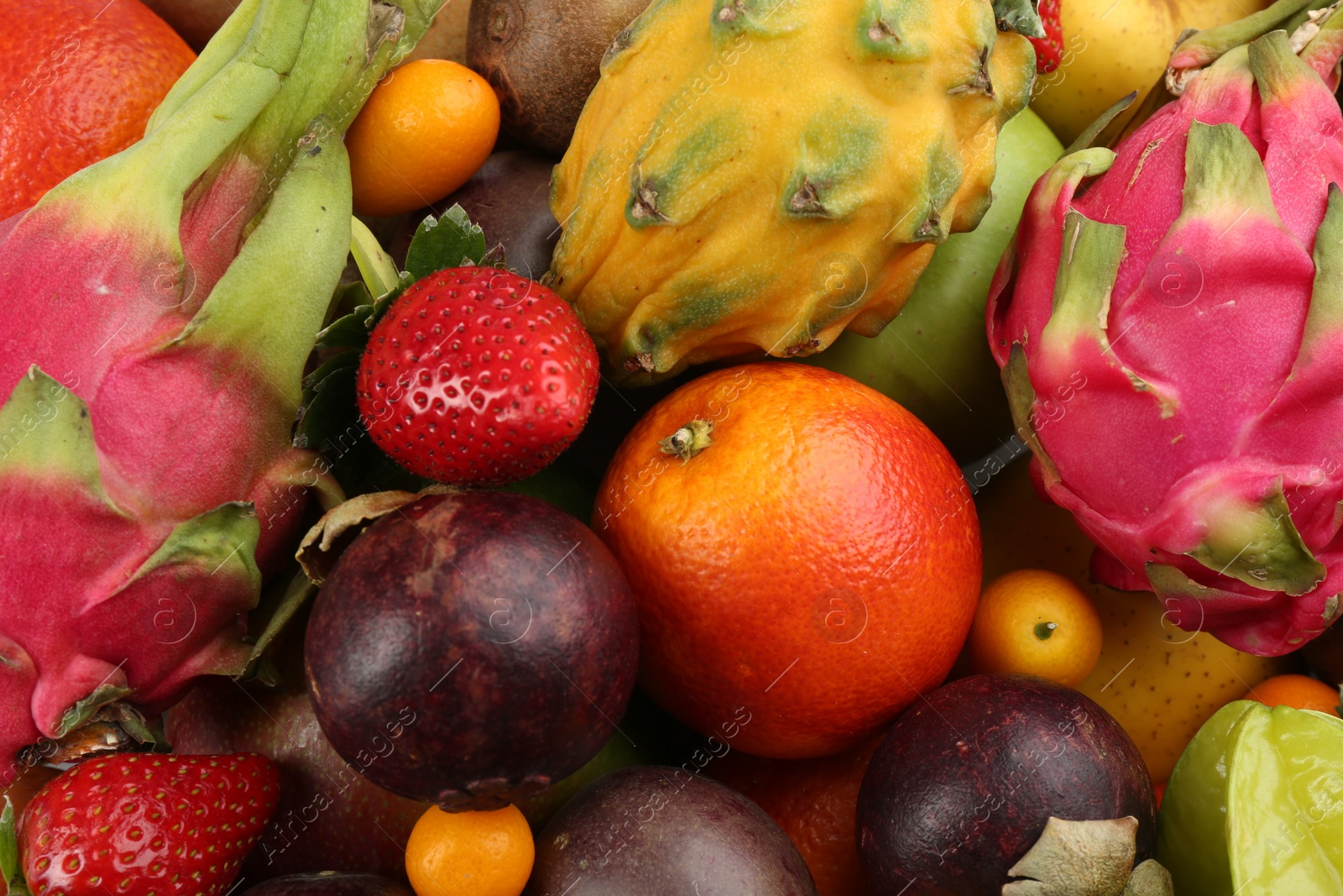 Photo of Assortment of fresh exotic fruits as background, top view