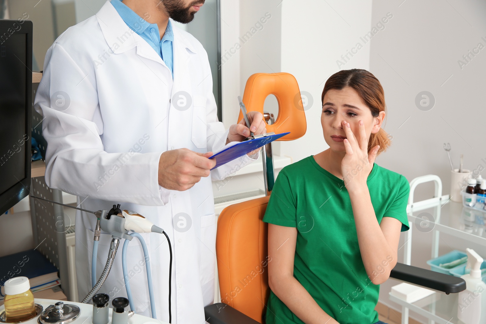 Photo of Troubled woman visiting professional otolaryngologist in clinic