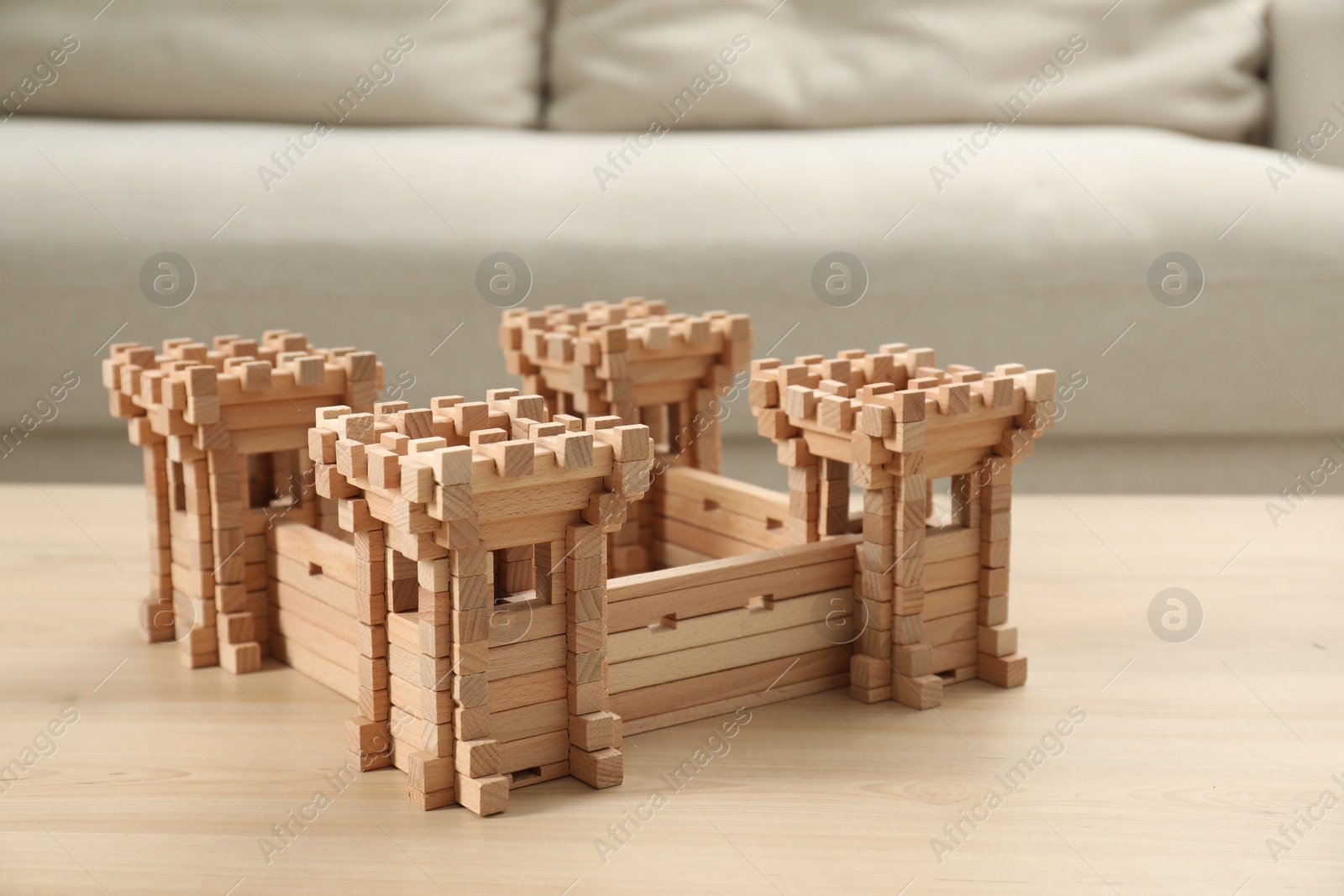 Photo of Wooden fortress on table indoors. Children's toy