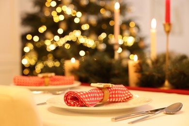 Photo of Festive table setting and beautiful Christmas decor indoors, space for text. Interior design
