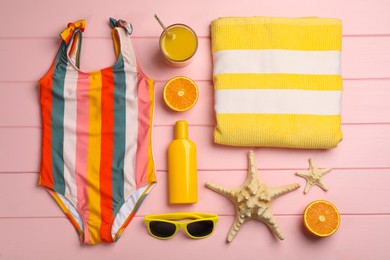 Photo of Flat lay composition with beach objects on pink wooden background