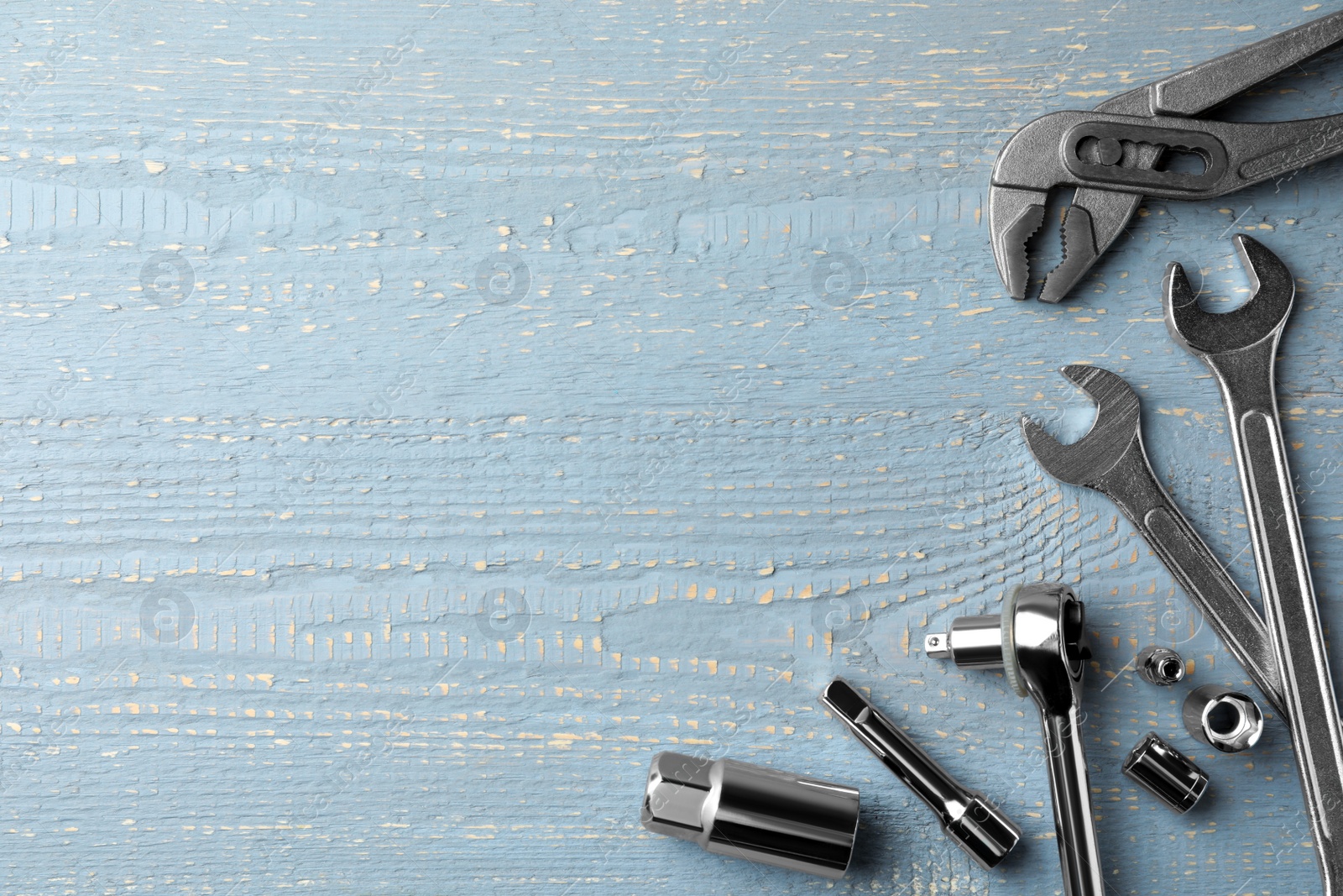 Photo of Modern auto mechanic's tools on grey wooden table, flat lay. Space for text