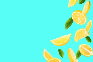 Fresh ripe lemons and green leaves on turquoise background. Space for text