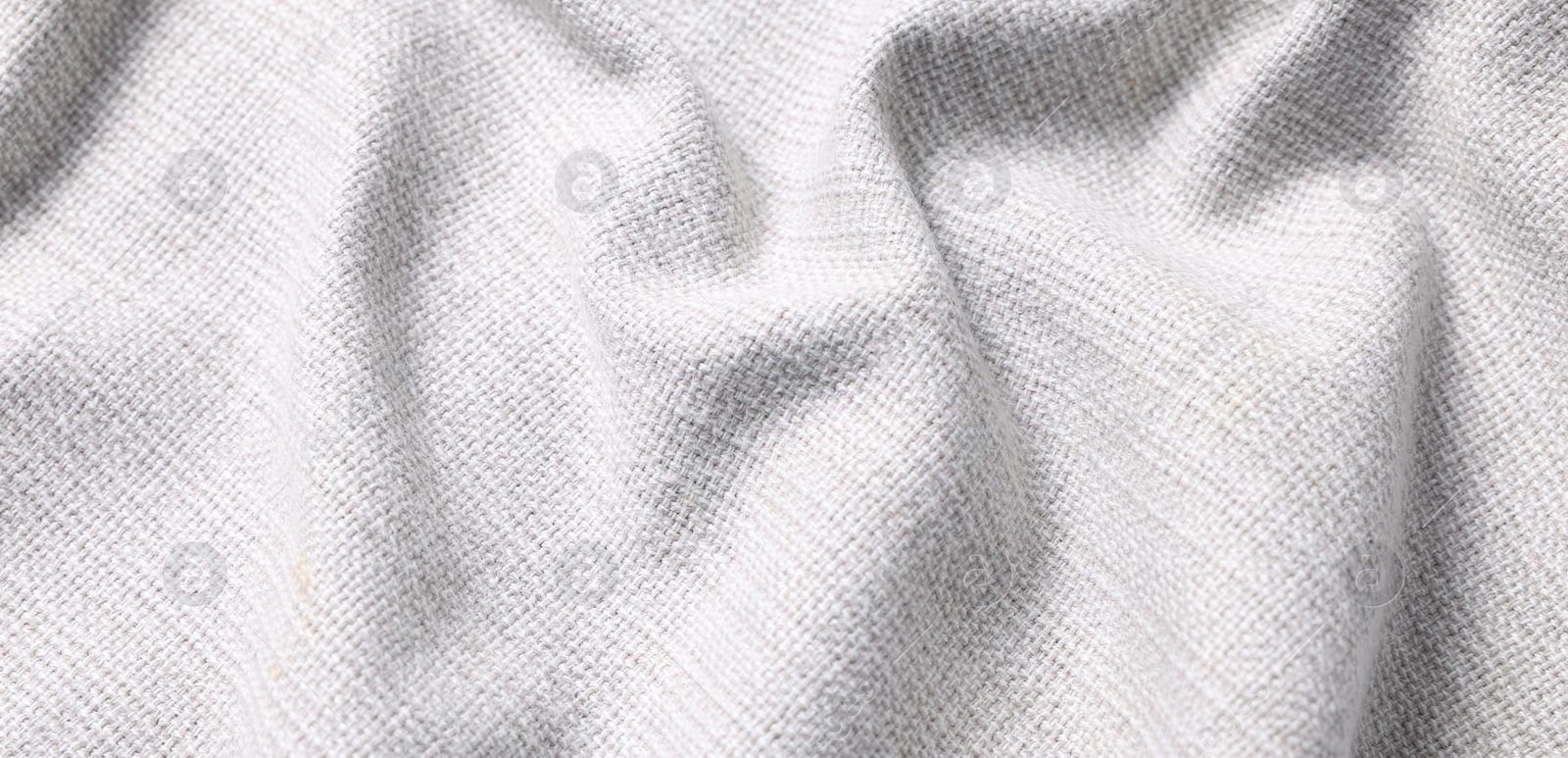 Photo of Texture of white crumpled fabric as background, closeup