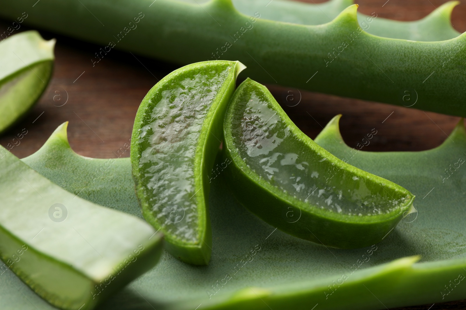 Photo of Fresh aloe vera pieces on table, closeup