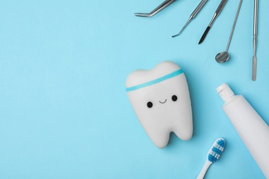 Photo of Flat lay composition with dentist tools and tooth on color background. Space for text
