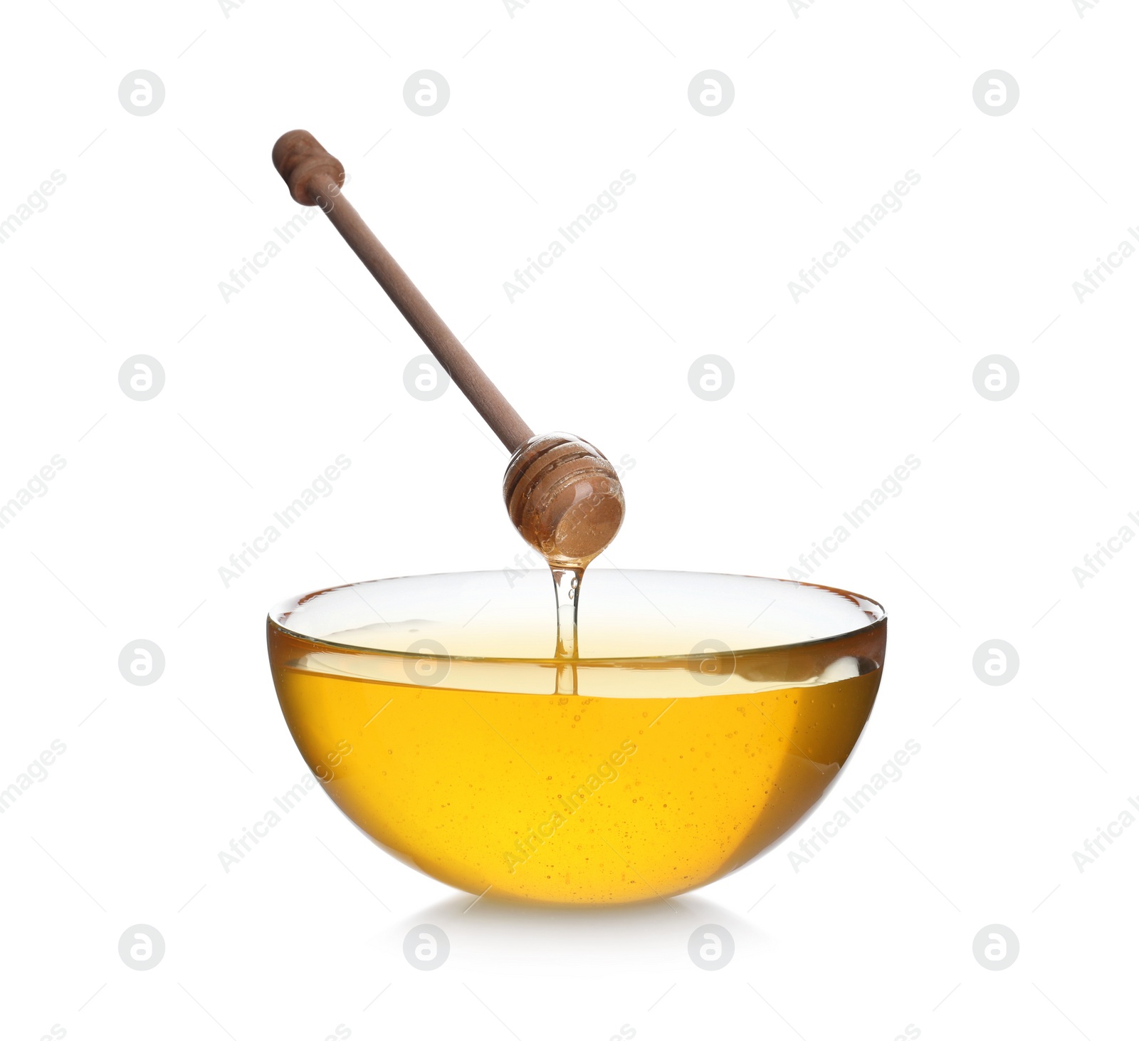 Photo of Honey dripping from wooden dipper into bowl isolated on white