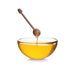 Photo of Honey dripping from wooden dipper into bowl isolated on white