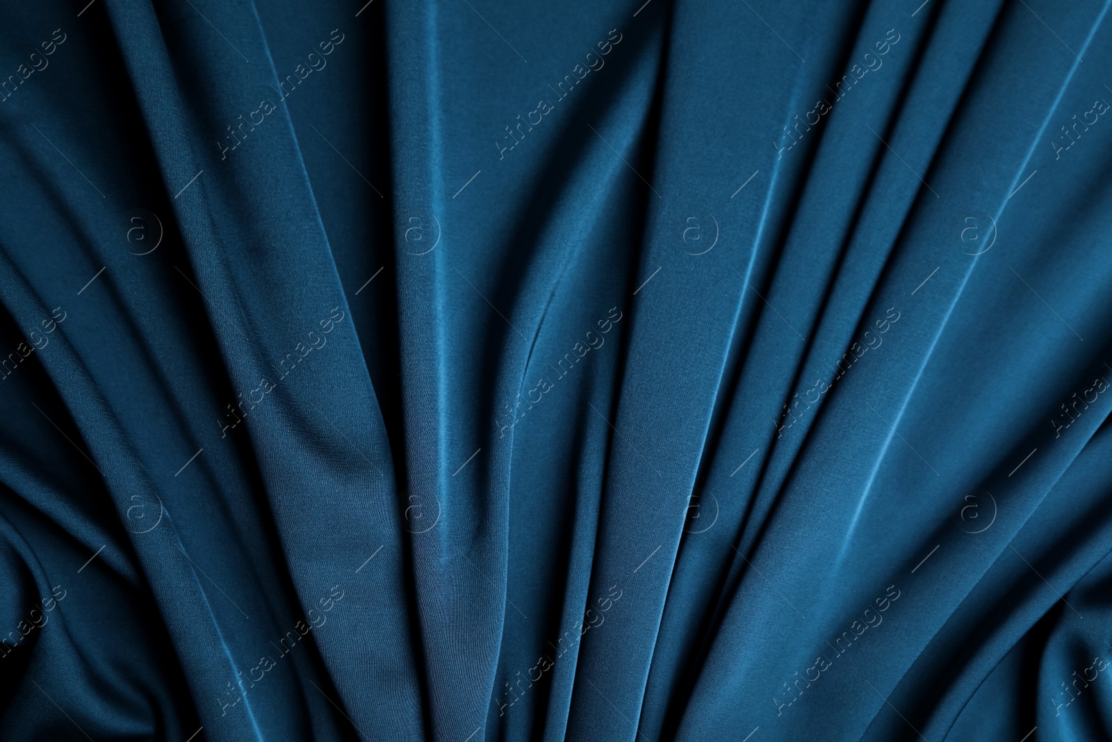 Image of Crumpled dark blue silk fabric as background, top view