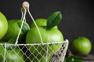 Photo of Fresh ripe sweeties in metal basket, closeup