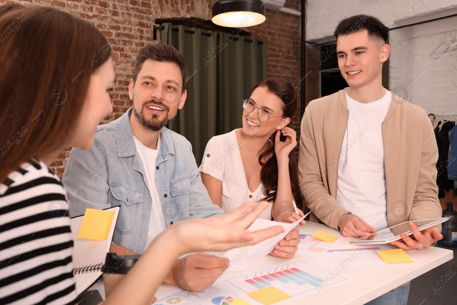 Photo of Team of employees working together in office