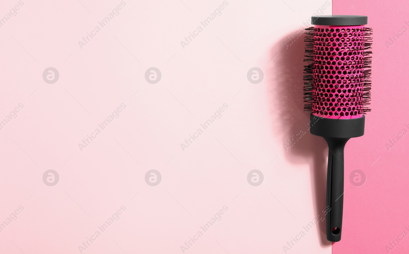 Photo of Round hair brush on color background, top view. Space for text