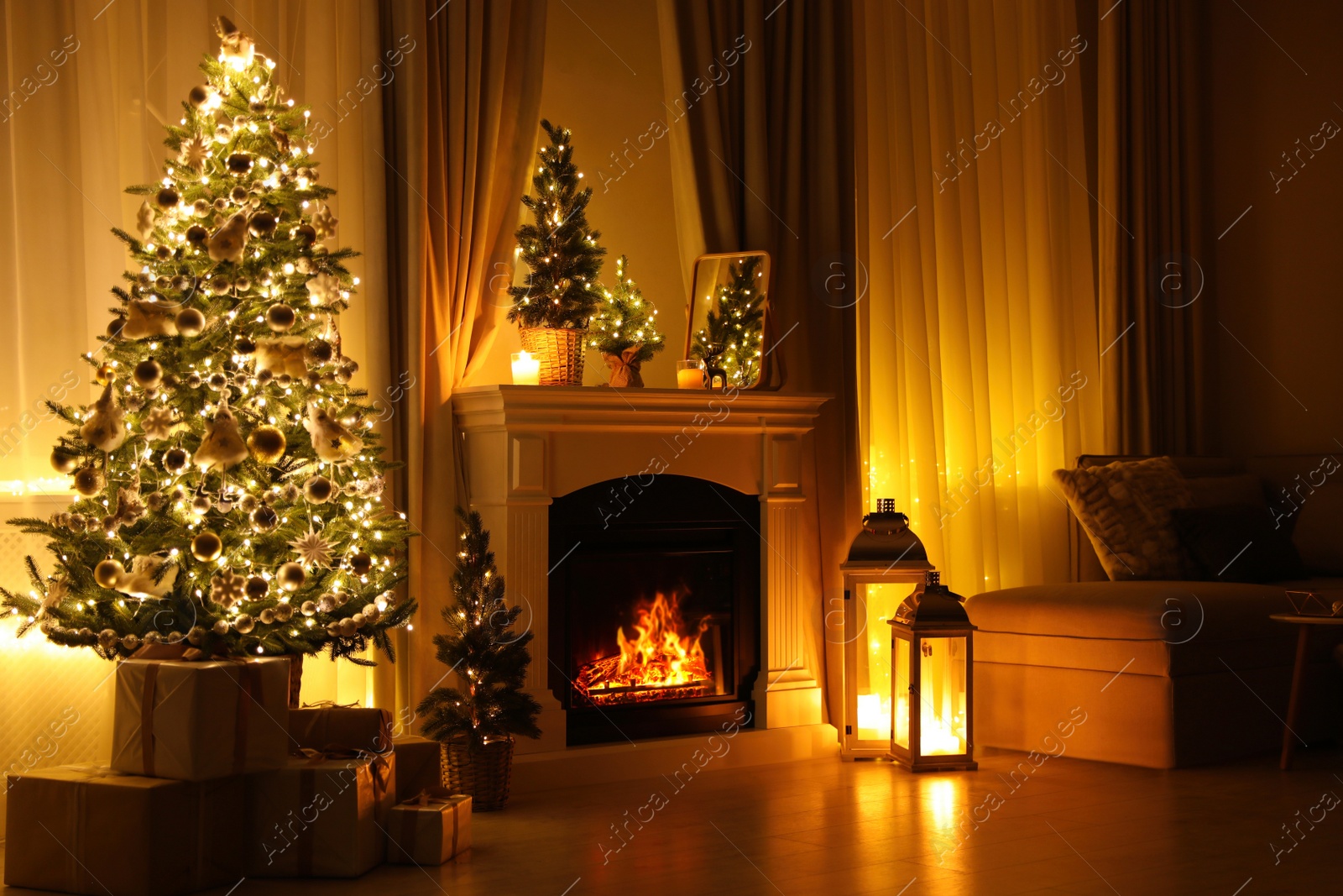 Photo of Stylish living room interior with beautiful fireplace, Christmas tree and other decorations at night