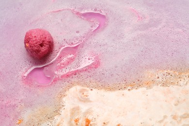 Photo of Beautiful pink bath bomb dissolving in water