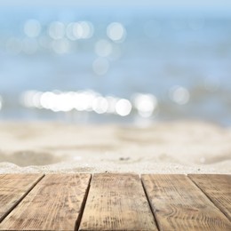 Empty wooden surface on beach near sea. Summer season