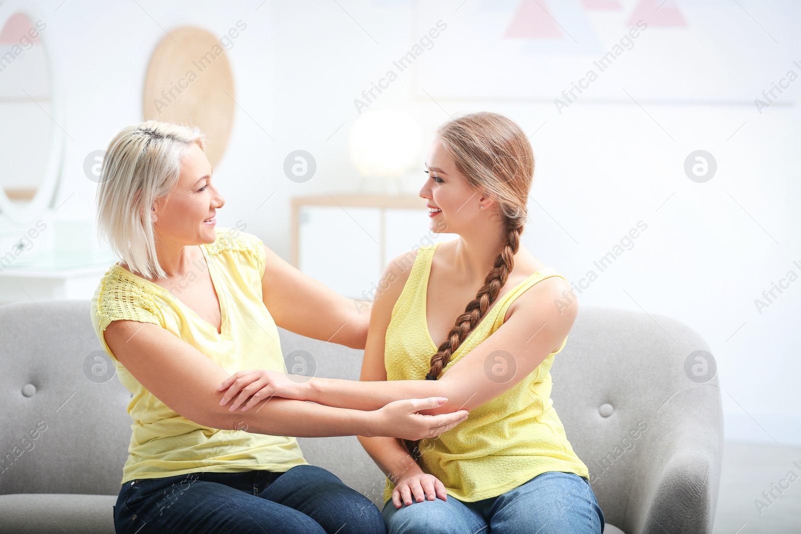 Photo of Mother and her adult daughter spending time together at home