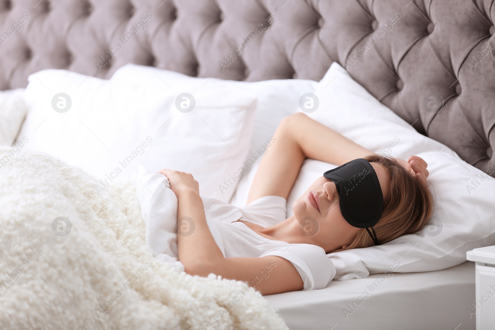 Photo of Young beautiful woman with mask sleeping in bed at home. Early morning