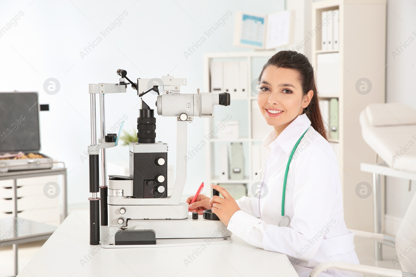 Photo of Female children's doctor with ophthalmic equipment in office