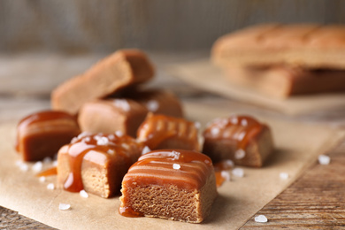 Salted caramel on wooden table, closeup view