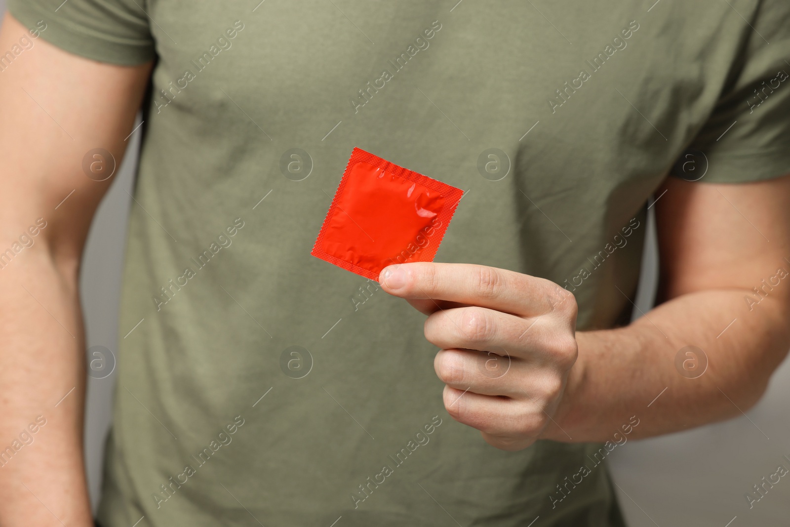 Photo of Man holding pack of condom, closeup view