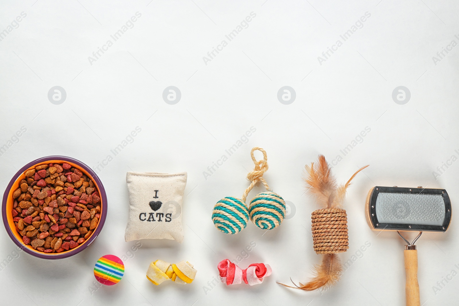 Photo of Cat's accessories and food on white background