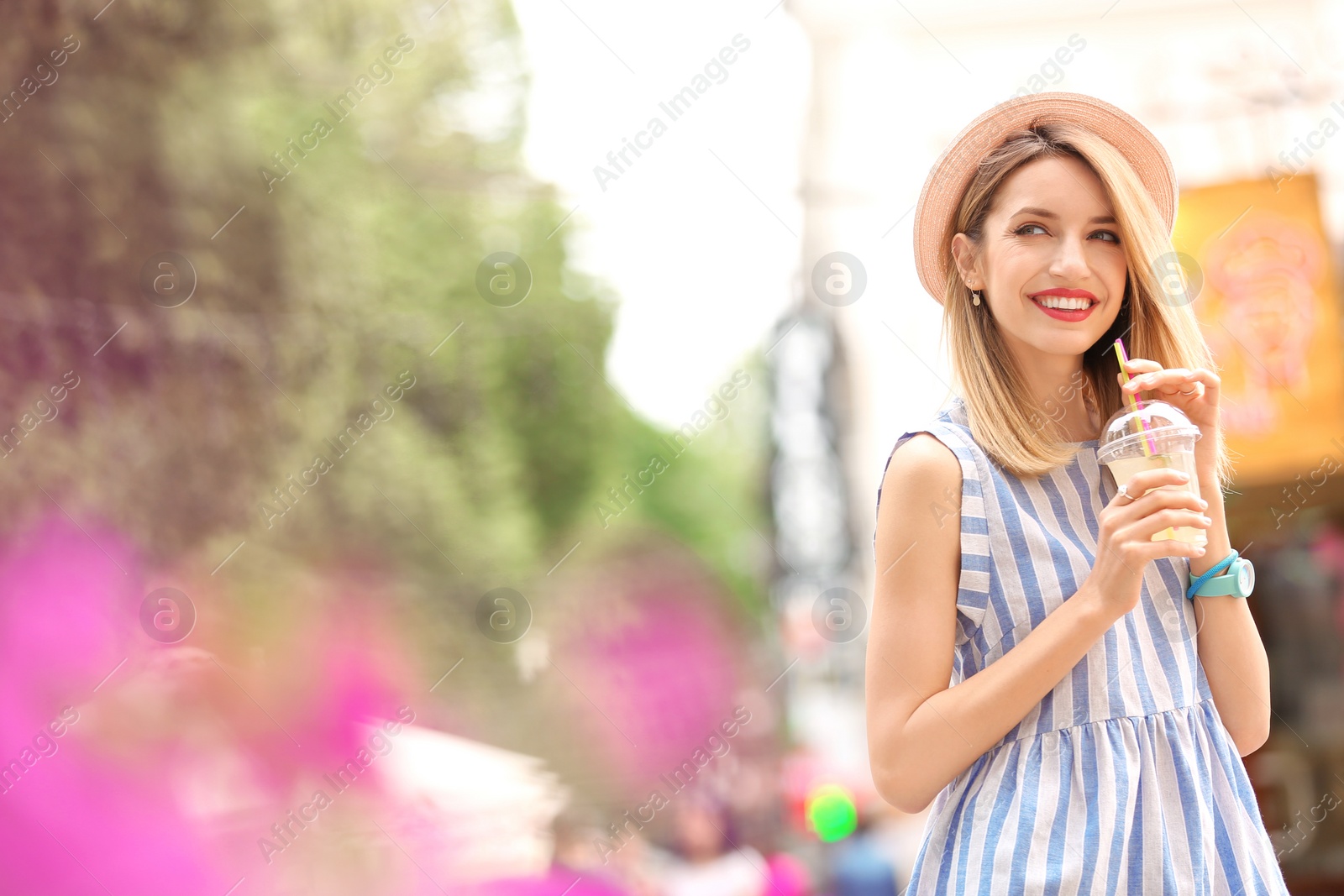 Photo of Young woman with cup of tasty lemonade outdoors