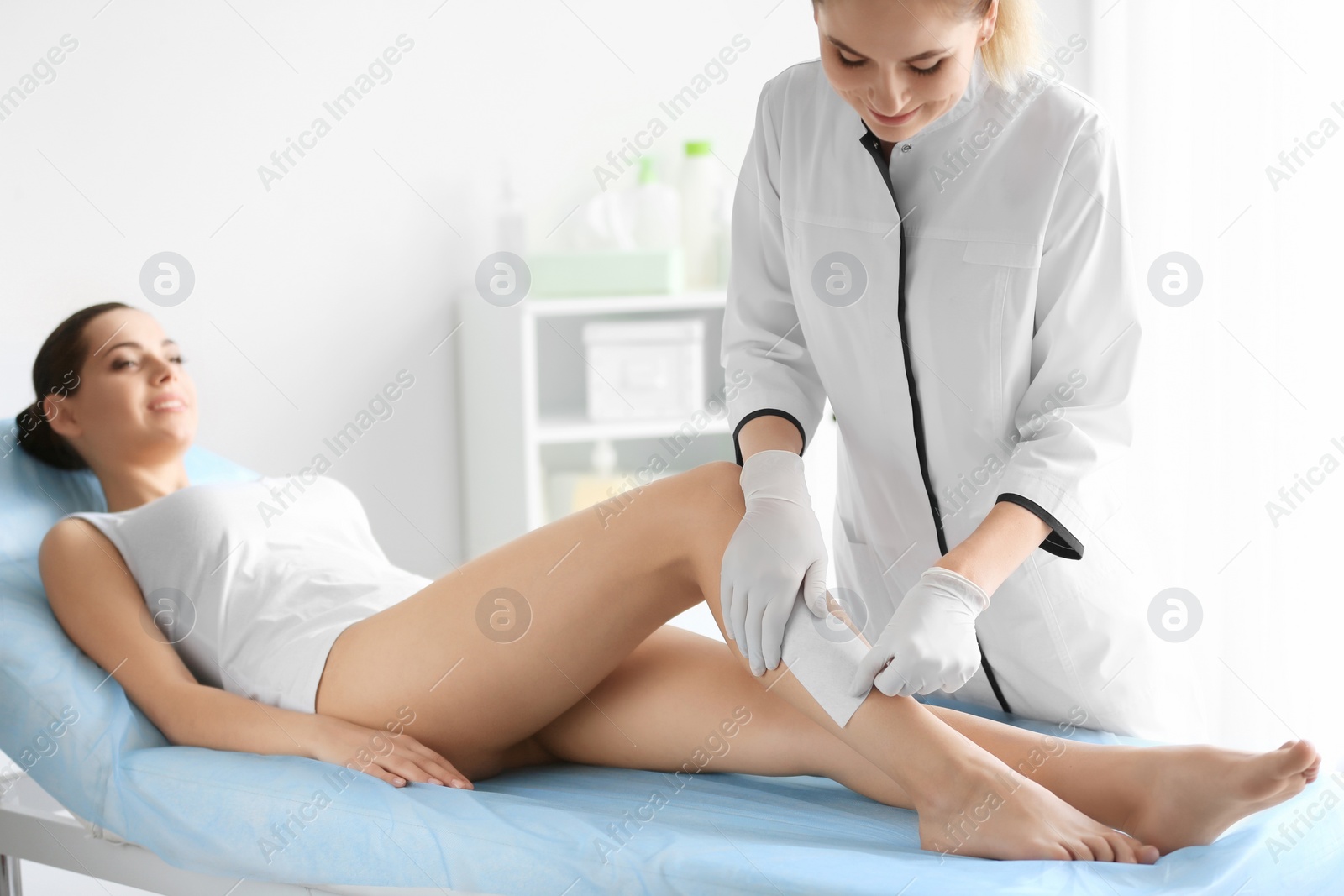 Photo of Woman getting wax epilation in salon