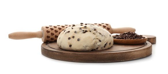 Photo of Wooden board with raw wheat dough, chocolate chips and rolling pin on white background