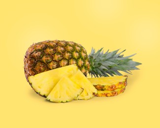 Image of Cut and whole pineapples on light yellow background