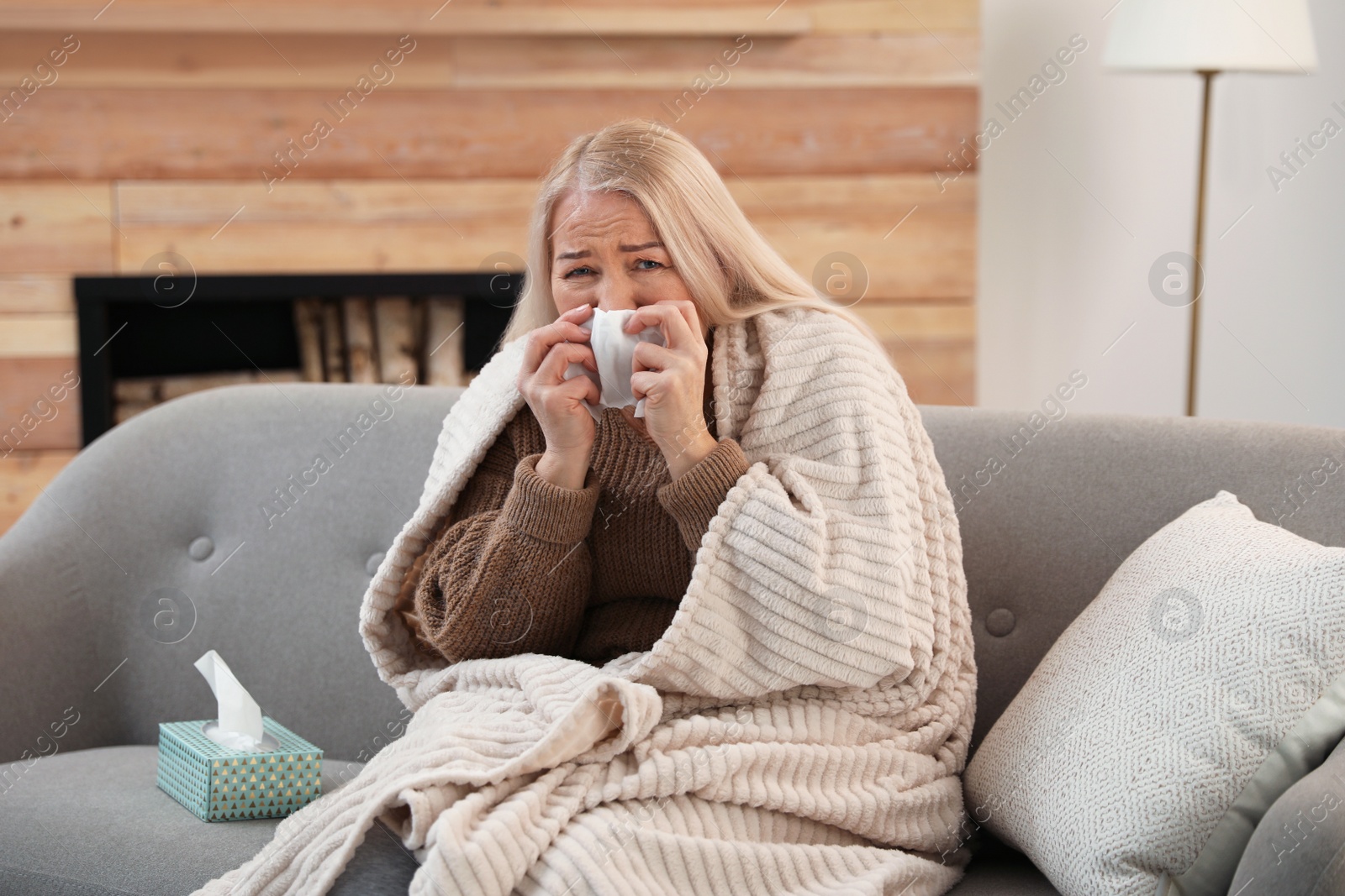 Photo of Mature woman suffering from cold at home. Dangerous virus