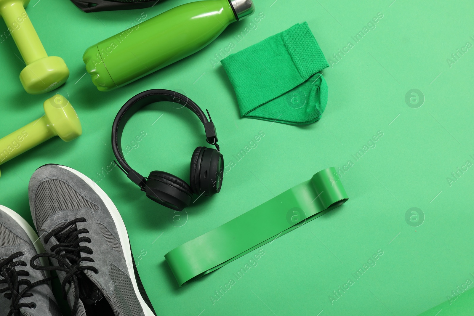 Photo of Different sports equipment on green background, flat lay