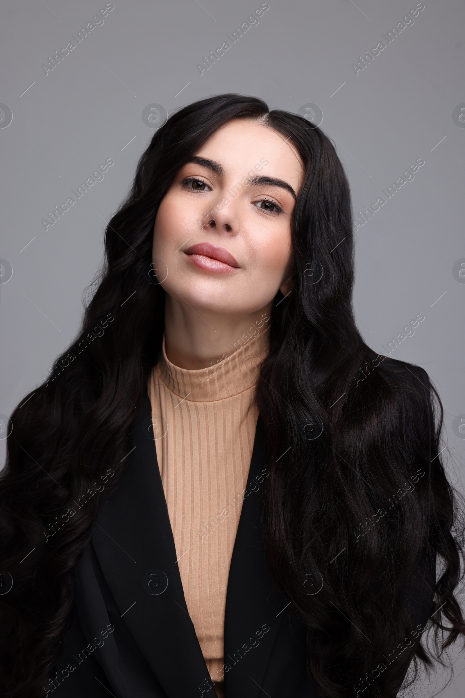 Photo of Beautiful woman in black jacket on gray background